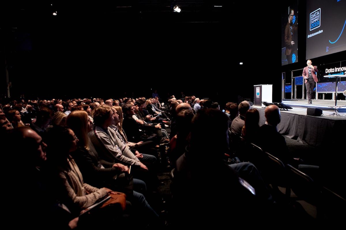 Photo of attendees listening to a speaker