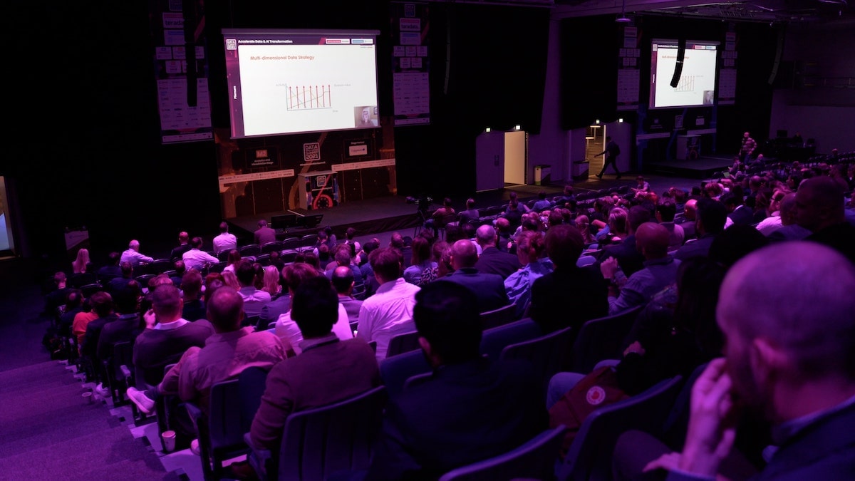 Photo of attendees listening to a speaker